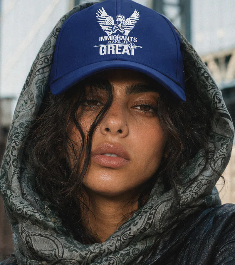 A wearer in the navy Legacy Cap and a printed scarf